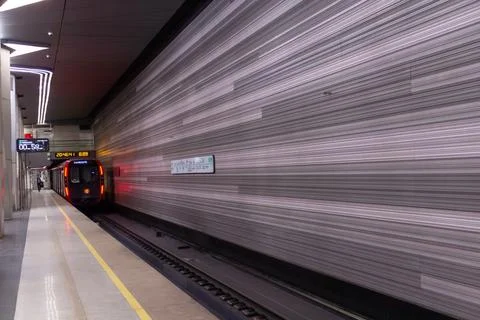 A fast moving train approaching subway station with blurred motion Фото