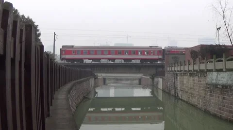 Fast moving train going through a bridge above a river Stock Footage 45904904
