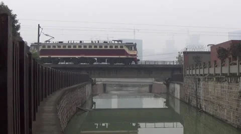 Fast moving train going through a bridge above a river Stock Footage 45905359
