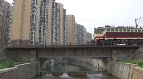 Fast moving train going through a bridge above a river Stock Footage 45954423