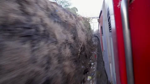 Fast moving train view along curved railway track in hillside Stock Footage 333684390