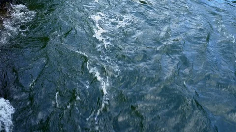 Fast moving water directly below a bridge Stock Footage 115302356
