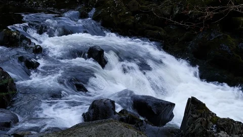 Fast moving water down stream across rocks Stock Footage 104907253