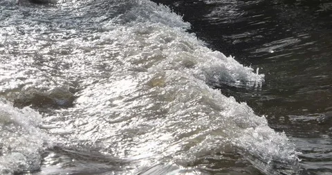 Fast moving water flows in the river in winter, close up Stock Footage 102579595