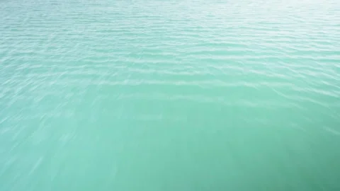 Fast-moving water from a sun-drenched boat in the waters of Bahrain Stock Footage 244888436