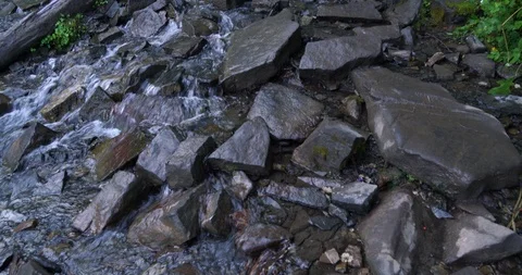 Fast-moving water trailing over a hiking path toward the top of Mount Timpanogos Stock Footage 120230947
