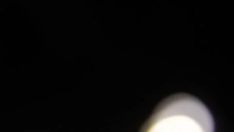 Fast moving white bokeh to the right in the dark 動画素材 317482301