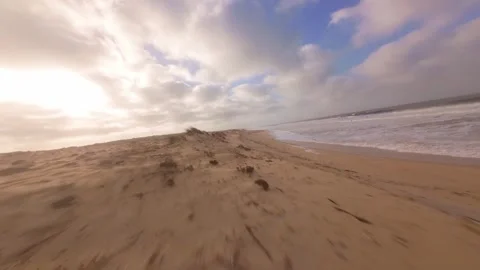 Fast-paced beach scene with ocean spray and textured sand Stock Footage 345149620