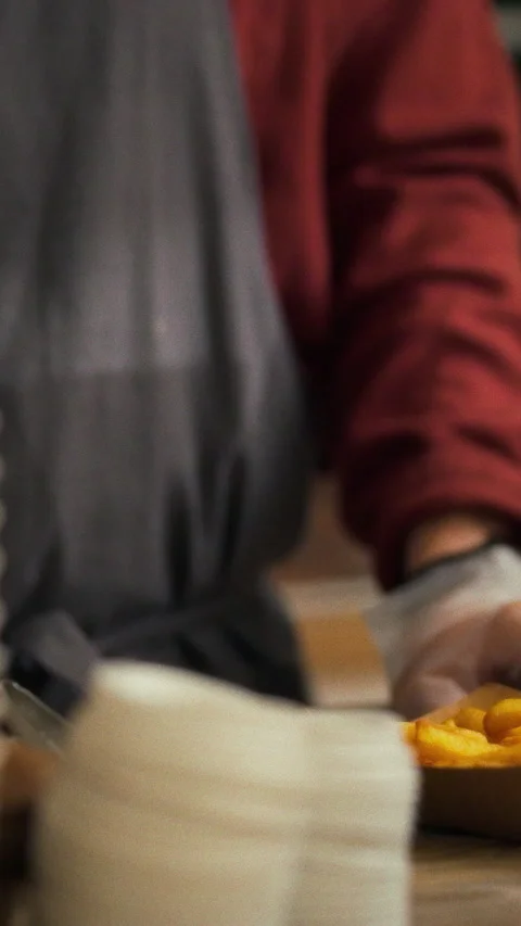In a fast-paced commercial kitchen a skilled worker meticulously assembles d Stock Footage 331600336