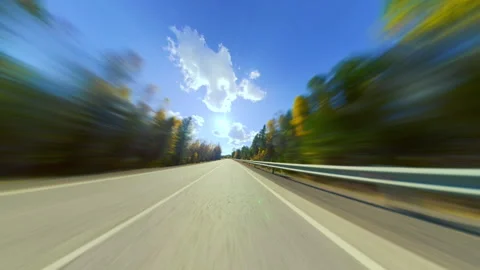 Fast-paced drive through scenic countryside road with motion blur. Video stock 295246219