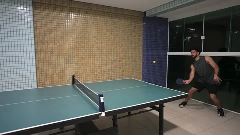 Fast-paced time-lapse of a man playing an energetic game of ping pong or table Stock Footage 317757665
