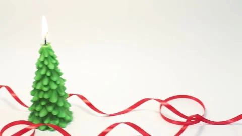 Fast panning from left to right of burning candle in shape of fir tree Stock Footage 143660130