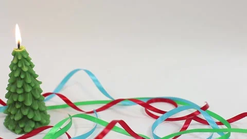 Fast panning from left to right of burning candle in shape of fir tree Stock Footage 143660196