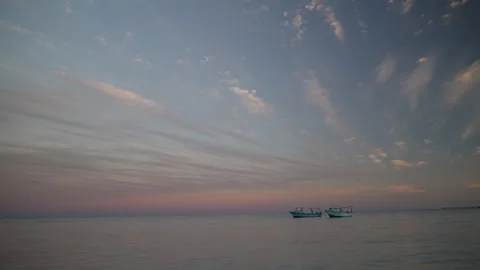 Fast pending clouds, sunset on the beach, boat, no people, copy space 스톡 동영상 231542479