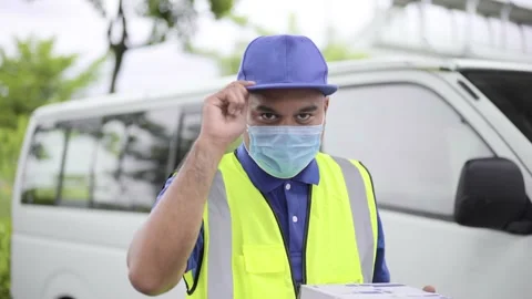 Fast post shipment service concept. Young asian deliveryman wear face mask to pr Stock Footage 137437167