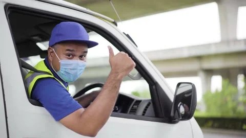 Fast post shipment service concept. Young asian deliveryman wear face mask to pr Stock Footage 137630340