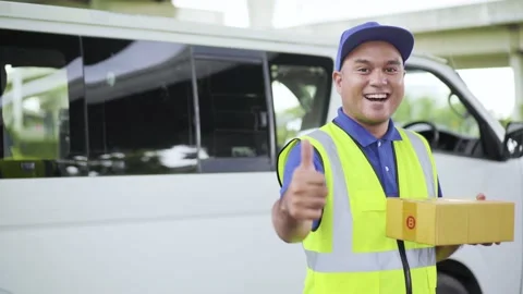 Fast post shipment service concept. Young asian deliveryman wearing blue cap sta Stock-Footage 137630431