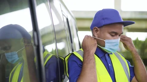 Fast post shipment service concept. Young asian deliveryman wearing face mask to Stock Footage 137630462