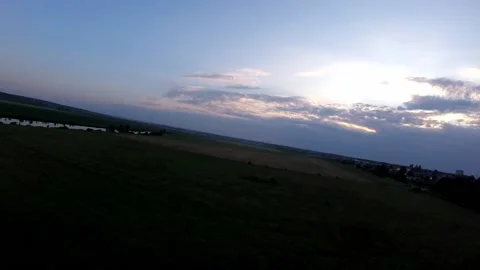 Fast quadcopter drone flight low to the ground on sunset. Flying in a circle Stock Footage 172494587