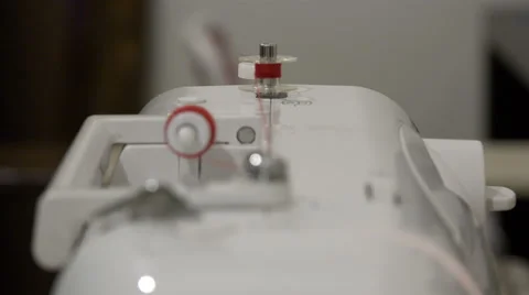 Fast red thread from the spool on the spool on the automatic sewing machine Stock Footage 67841223