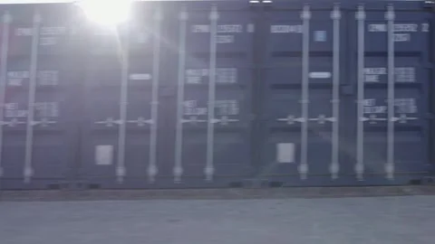Fast repeating pattern: Dolly shot past stacks of shipping containers Stock Footage 297248335