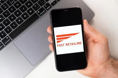 Fast Retailing mobile application on the smartphone screen. A mobile phone in a Stock Photos