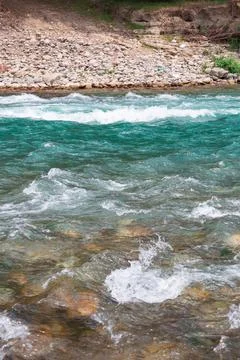 Fast river with rapids high in the mountains Stock Photos