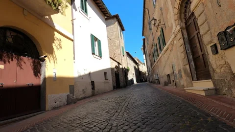 Fast road motorcycle ride in historic village and castle in Italy in Europe Stock Footage