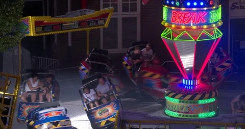 Fast rotating attraction at carnival fair in the evening, high angle shot Stock Footage 91887288
