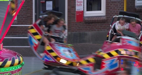 Fast rotating attraction at fair in the evening, high angle shot Stock Footage 91886669