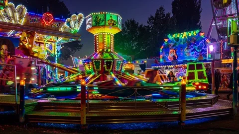 Fast-rotating carousel for small children on funfair at night with colorful ligh Stock-Footage 97444032