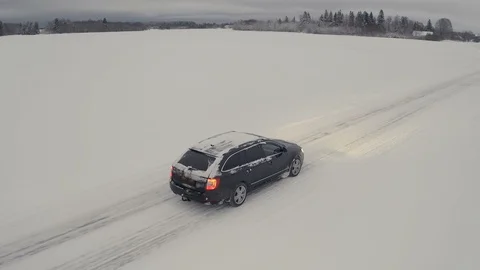 A fast running SUV car on a snowy road Stock Footage 111130245