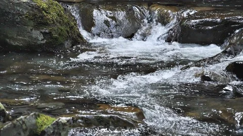 Fast rushing white water stream in slow motion Stock Footage 104752691