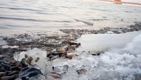 Fast shallow river forms the ice pieces on the shore Stock Footage 77690554