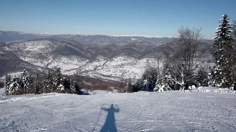 Fast Skier Rides Down the Snowy Slopes on a Pristine Day on the Mountain With 库存影片 72012614
