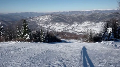 Fast Skier Rides Down the Snowy Slopes on a Pristine Day on the Mountain With Stockbeeldmateriaal 72012641