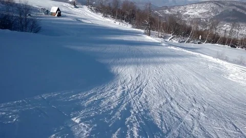 Fast Skier Rides Down the Snowy Slopes on a Pristine Day on the Mountain With Stock Footage 72012673