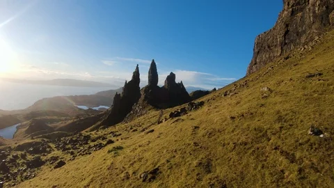 Fast slow motion fly around Old Man Storr rock formation.  drone aerial 4K Stock Footage 104578457