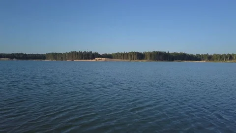 Fast speed fly over pond water on bright day Stock Footage 78771586