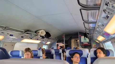 Fast speed train interior in Europe, diverse group of passengers traveling. Stock Footage 340394177