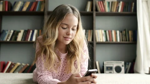 Fast speed of typing and sending message using telephone. Happy cute teen girl w Video stock 199488300