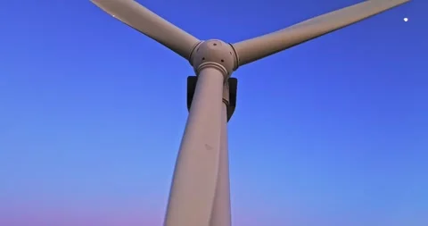Fast Spinning Wind Generator Blades On Pink Blue Hour Sky Aerial Cinematic Rise Stock Footage 300487684