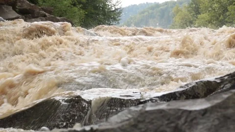 Fast stream of dirty water in river rapids and waterfall Stock Footage 119657667