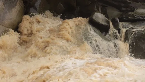 Fast stream of dirty water in river rapids and waterfall Stock Footage 119657922