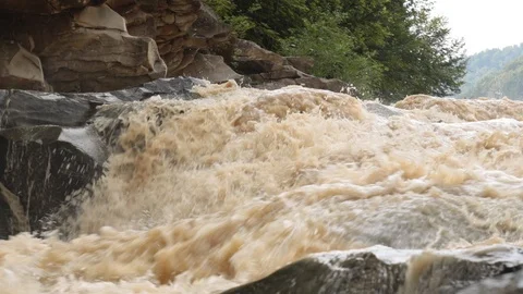 Fast stream of dirty water in river rapids and waterfall Stock Footage 119658205