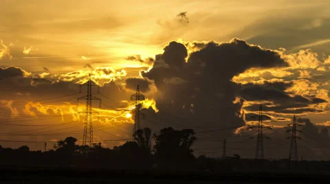 Fast sunset between ellectric pillars and big clouds in 4K timelapse Stock Footage 50887425