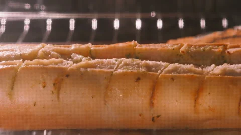 Fast Timelapse of Garlic Bread Baguette Cooking in Hot Oven as Slices Expand Stock Footage 337967672