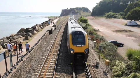 Fast train approaching on coast at Dawlish Warren Devon Stock Footage 29092432