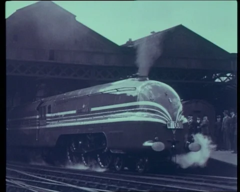 Fast train driving out of station with smoke coming out of chimney, UK 1966 Stock-Footage 132329402