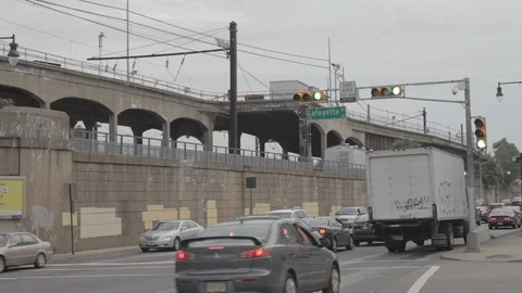 Fast Train Going Over Bridge Above Busy Street Stock Footage 100851938